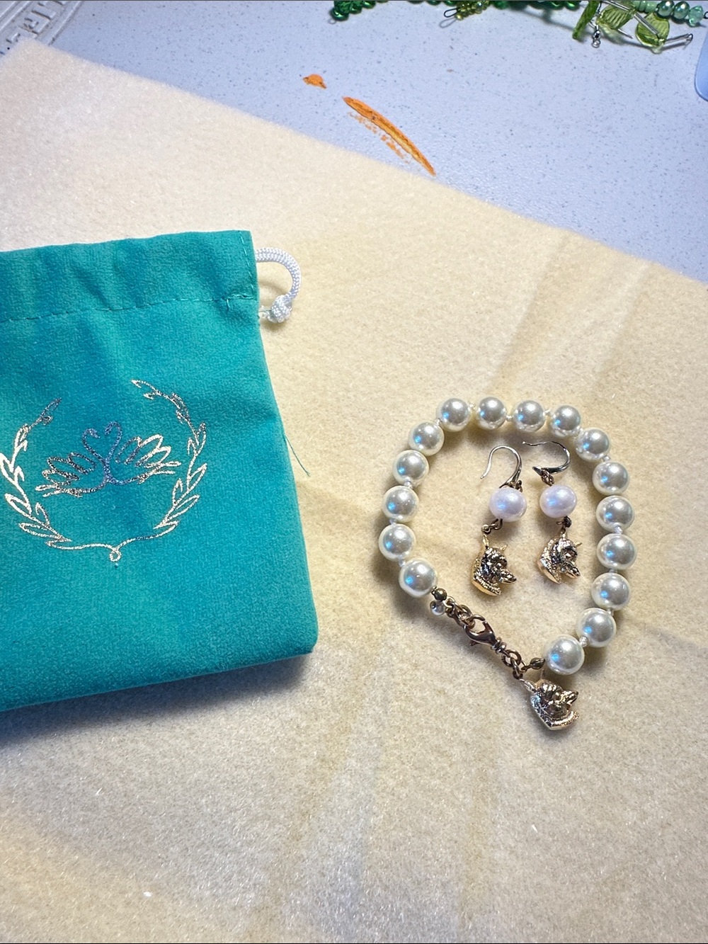 Kiel James Patrick Teal Pouch with Pearl Bracelet and Fox Charm Earrings